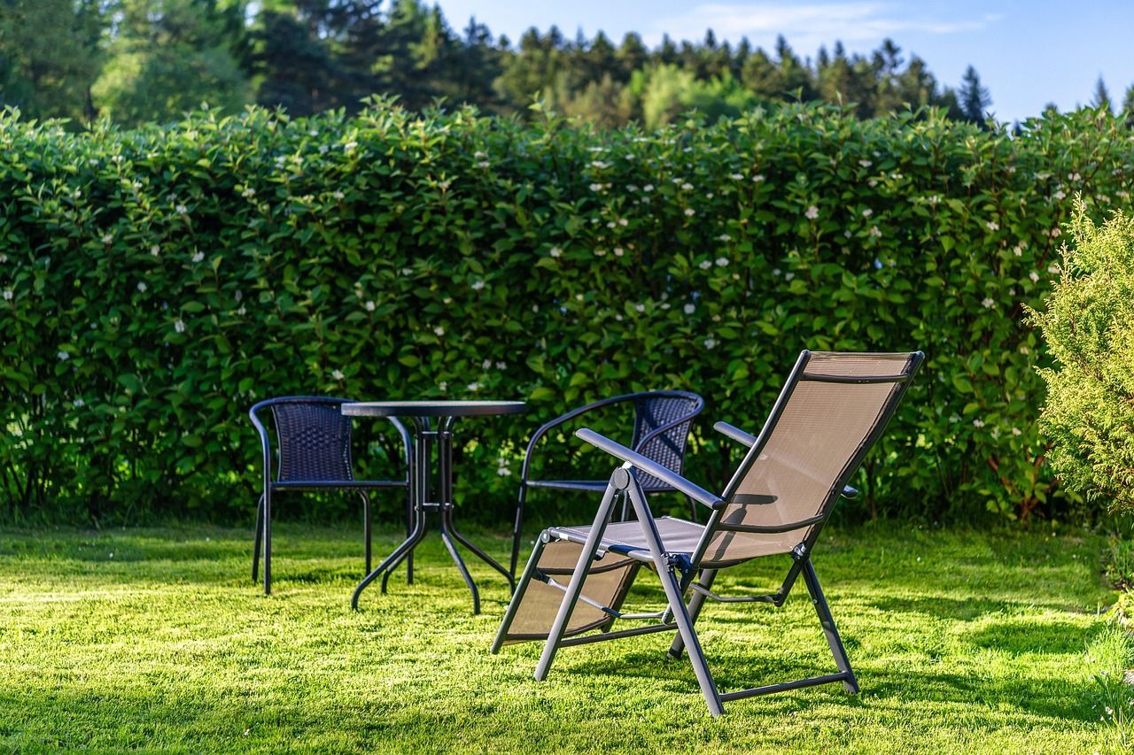 A table and chairs are sitting on a lush green lawn in Grand Haven, MI