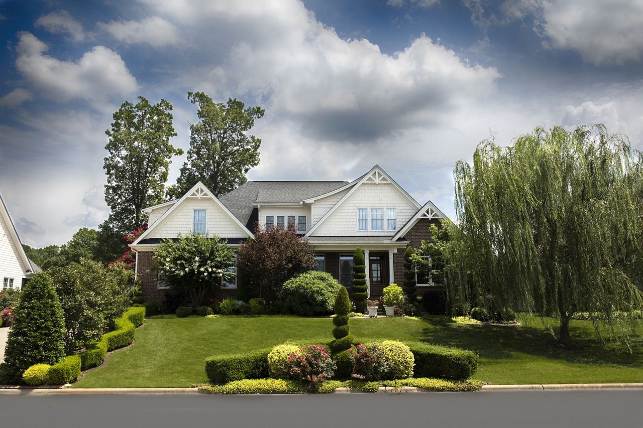 A large house with a lot of trees and a lush lawn in Grand Havens, MI