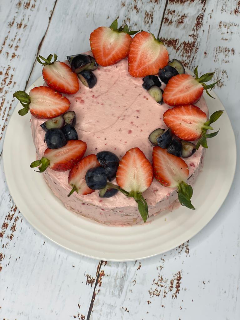 Strawberry cream cake decorated with fresh berries