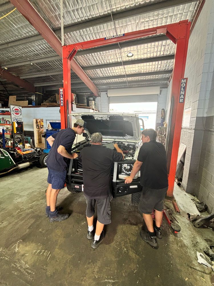 Mechanics Checking Car Engine