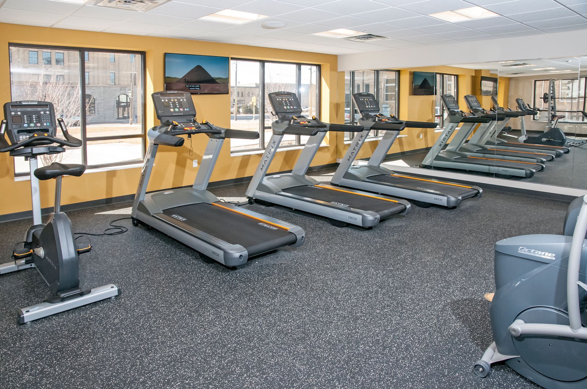Fitness room with treadmills and exercise equipment.