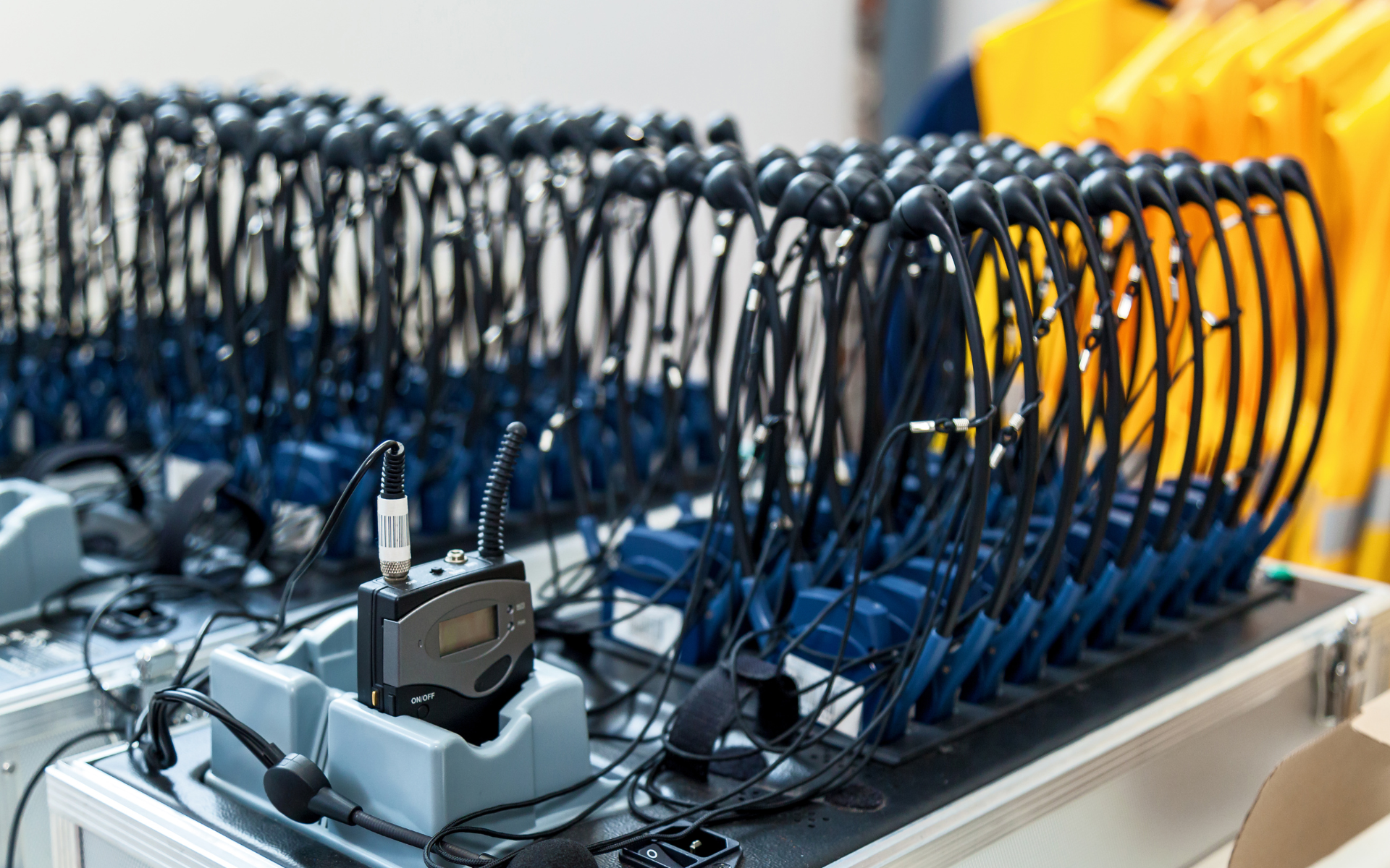 Rows of headsets and transmitters on a table, likely for simultaneous interpretation or tour groups.