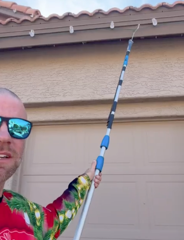 Keith Call removing Christmas lights at a home in Sun Lake Arizona