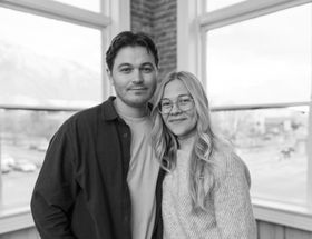 A man with a beard is wearing a plaid shirt