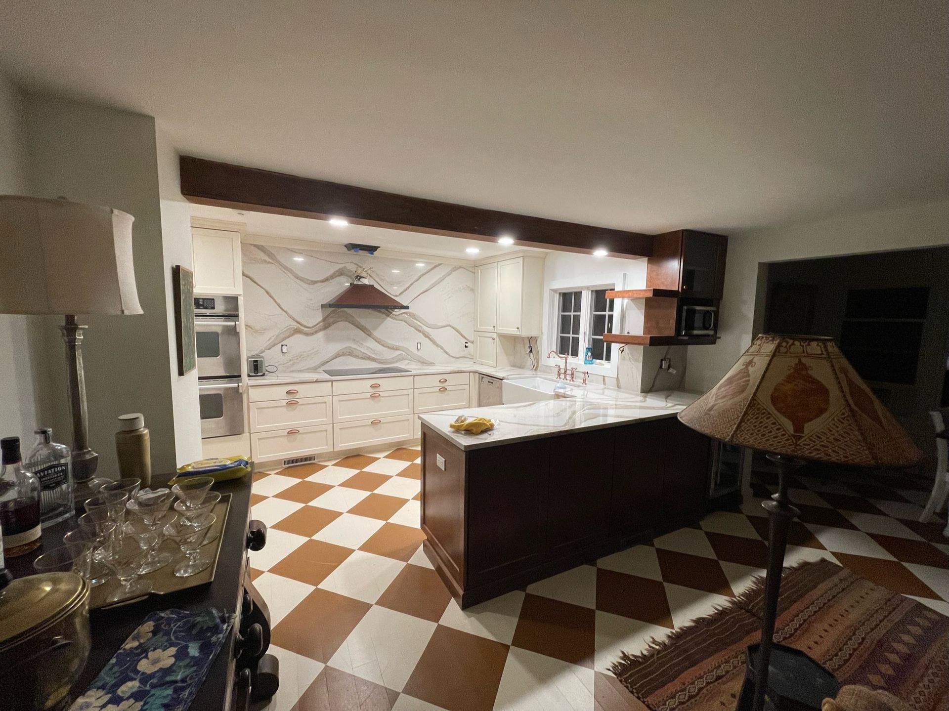 A kitchen with a checkered floor and a lamp