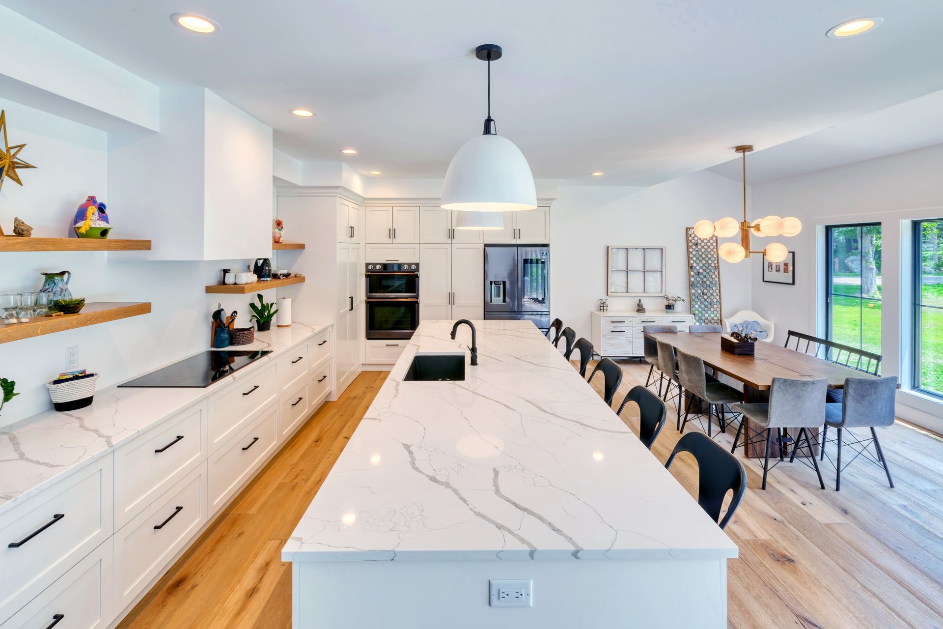A kitchen with a large island and a dining room in the background.