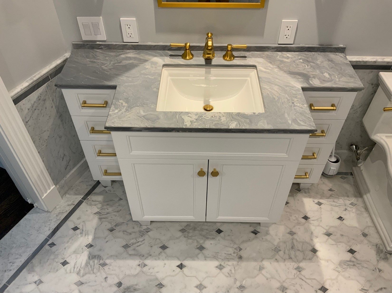 A bathroom with a sink and a toilet.