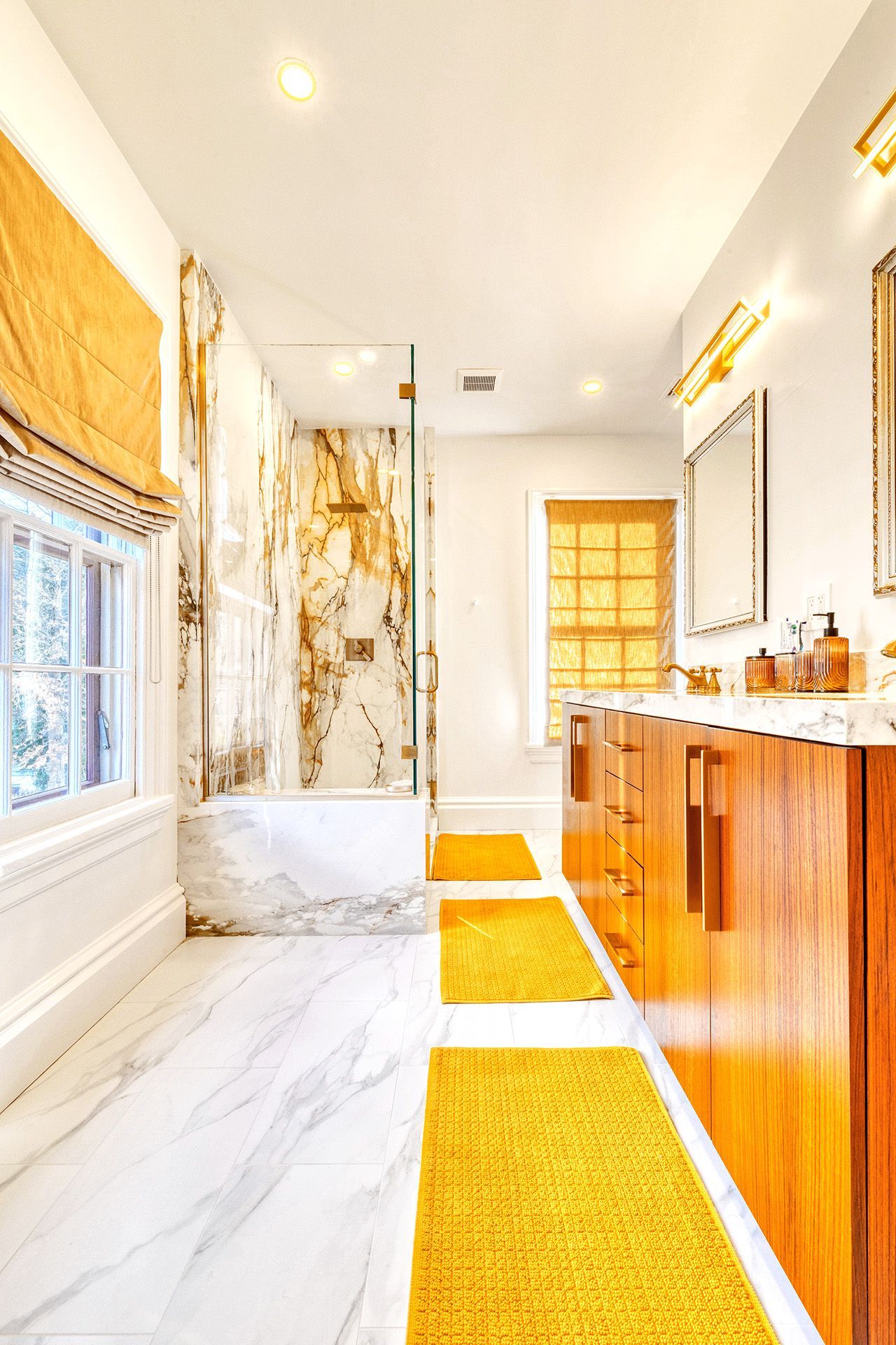 A bathroom with two sinks , a tub , and a walk in shower.