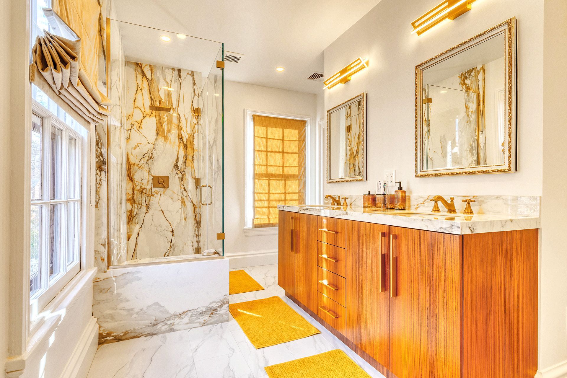 A bathroom with two sinks , a tub , and a shower.