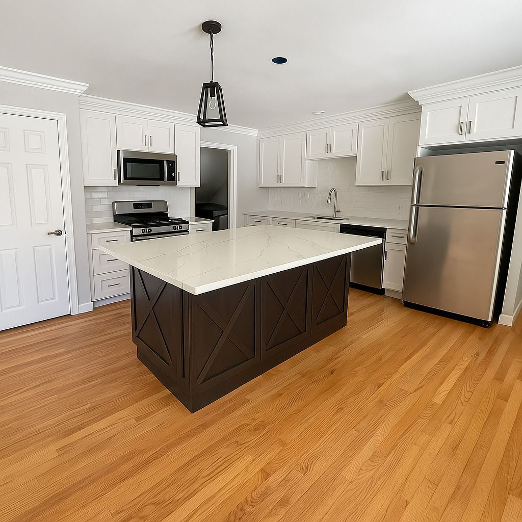 A kitchen with a large island and stainless steel appliances