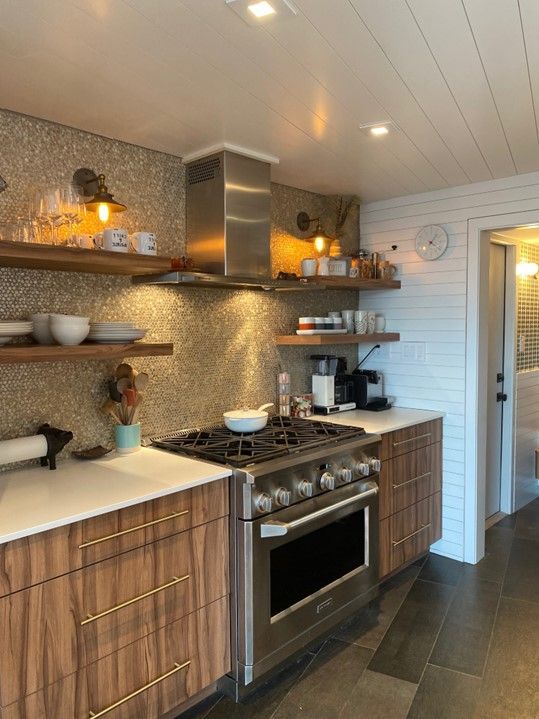 A kitchen with stainless steel appliances and wooden cabinets