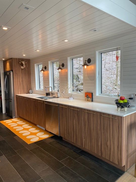 A kitchen with wooden cabinets and stainless steel appliances.