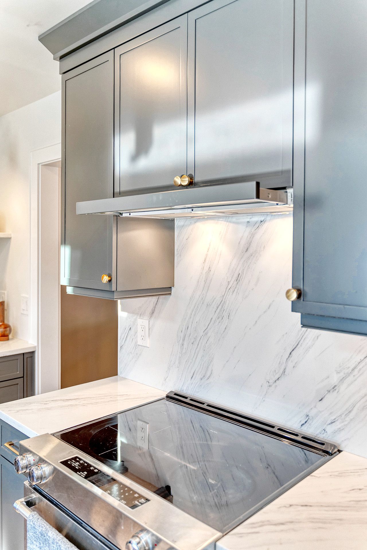 A kitchen with stainless steel appliances and a stove top oven.
