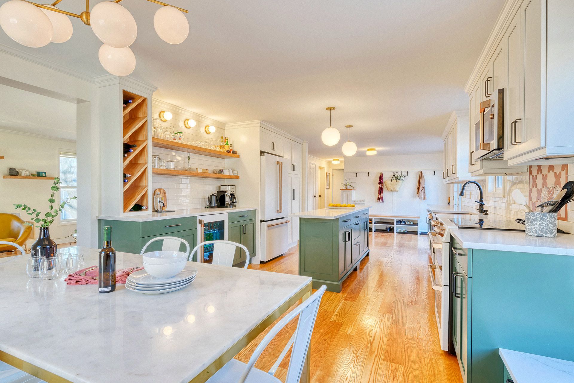 A kitchen and dining room in a house with a table and chairs.