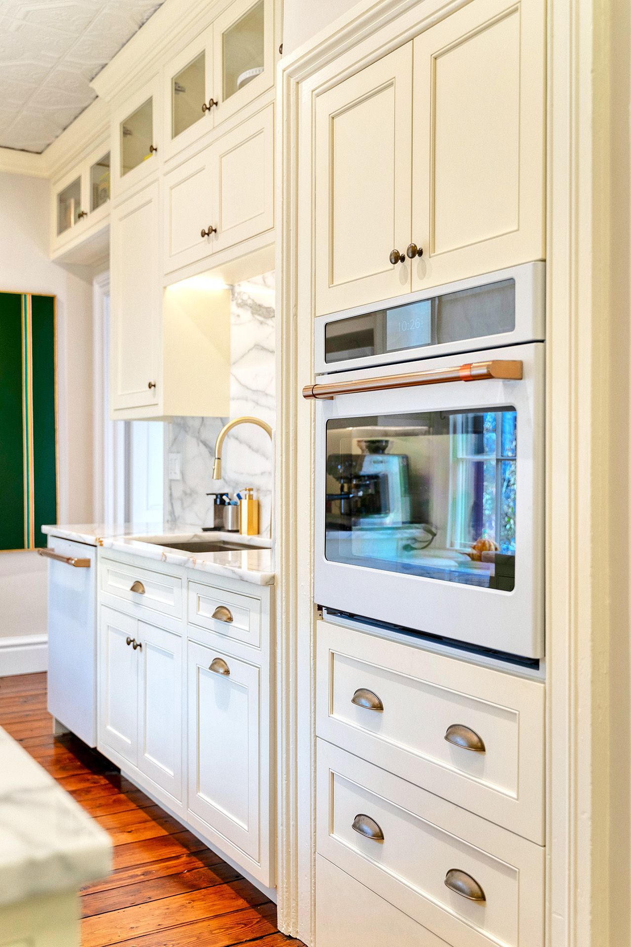 A kitchen with white cabinets and stainless steel appliances.