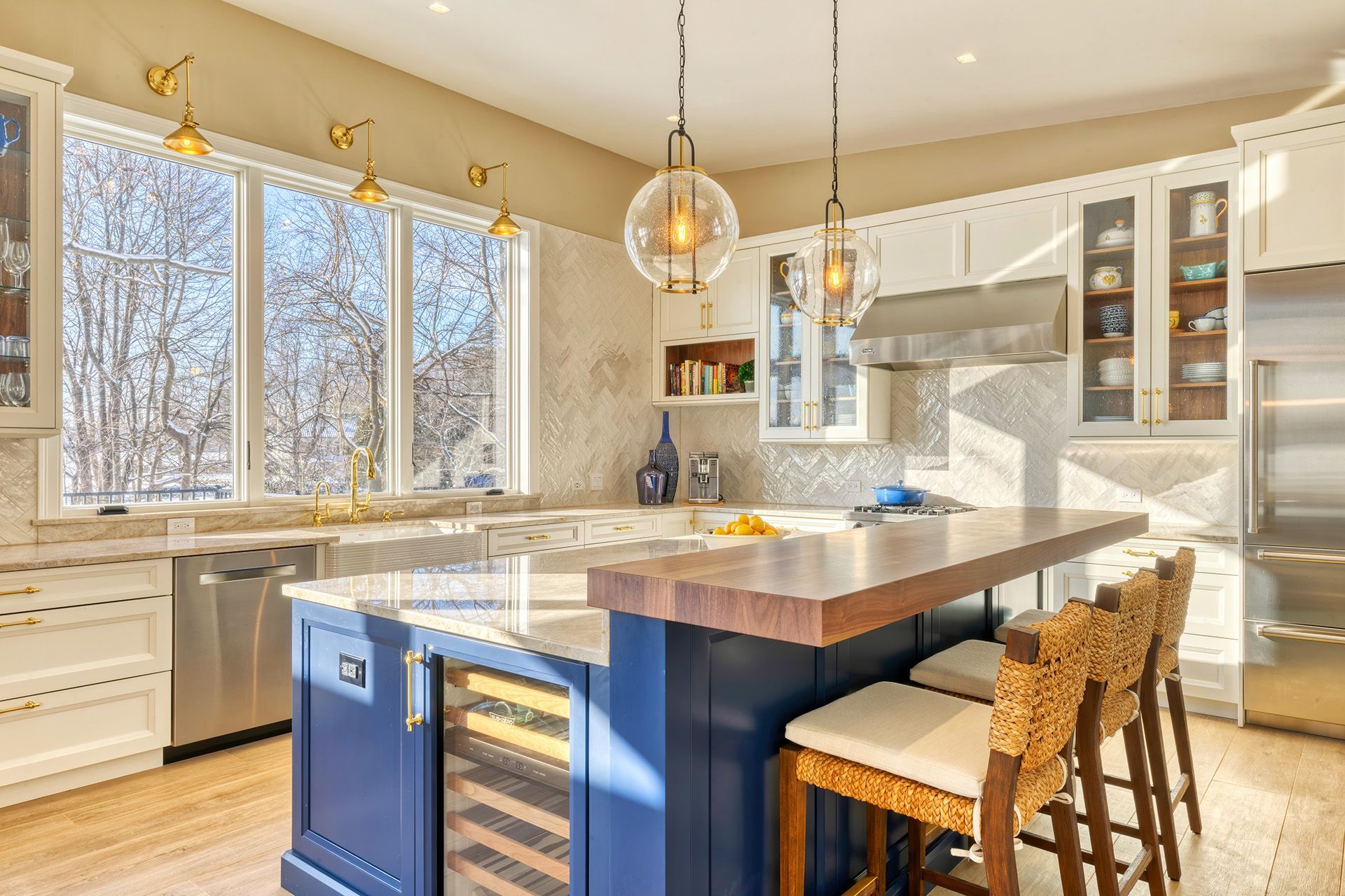 Blue and white kitchen with a granite countertop and blue cabinet base.  A blue sliding barn door is centered on the wall.