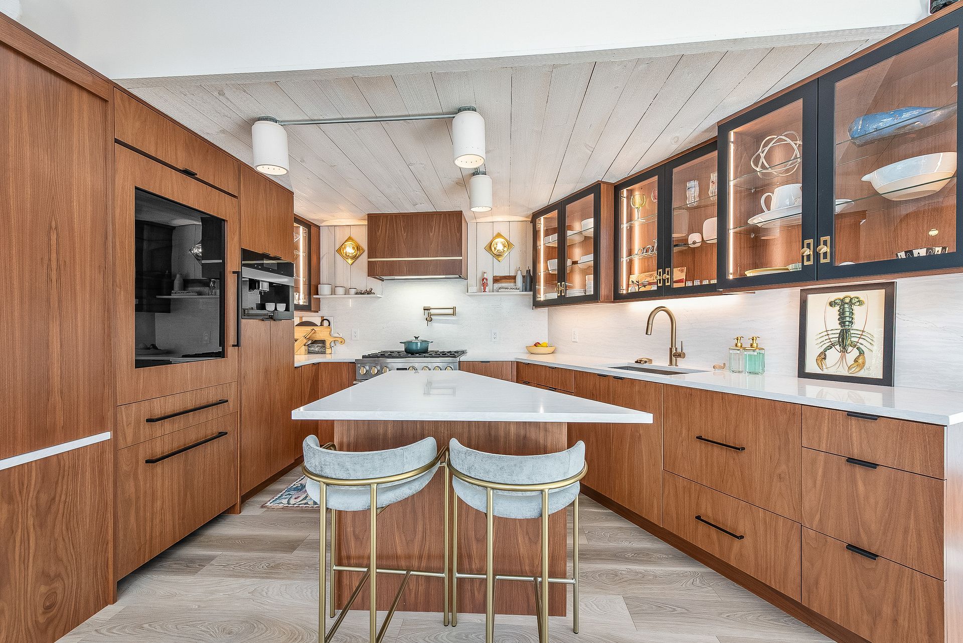 A kitchen with wooden cabinets and a large island.