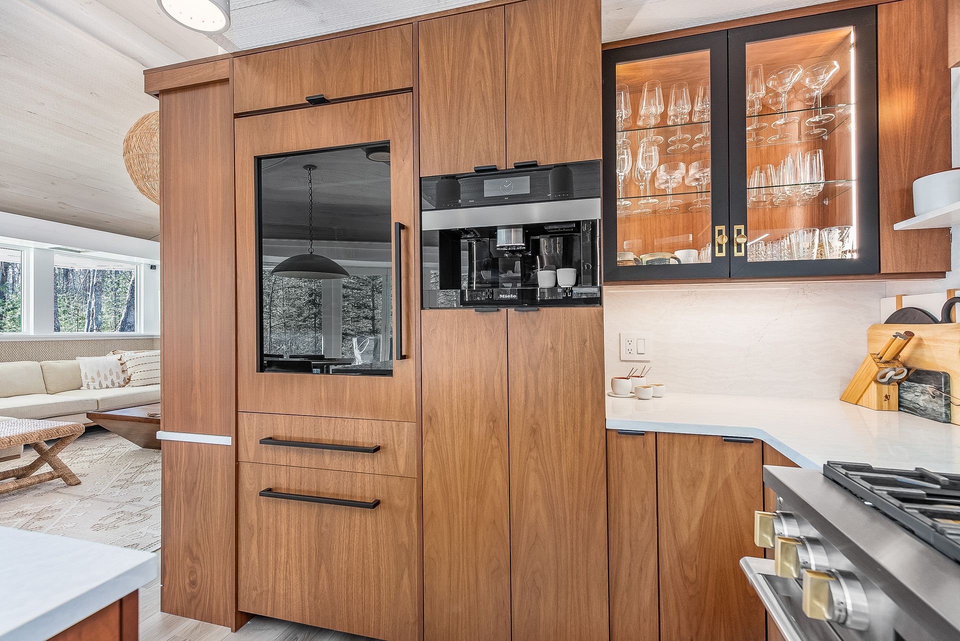 A kitchen with wooden cabinets , a stove , a refrigerator and a coffee maker.