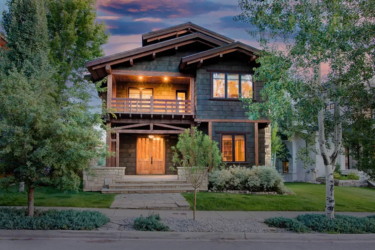 A large house with a lot of windows and trees in front of it.