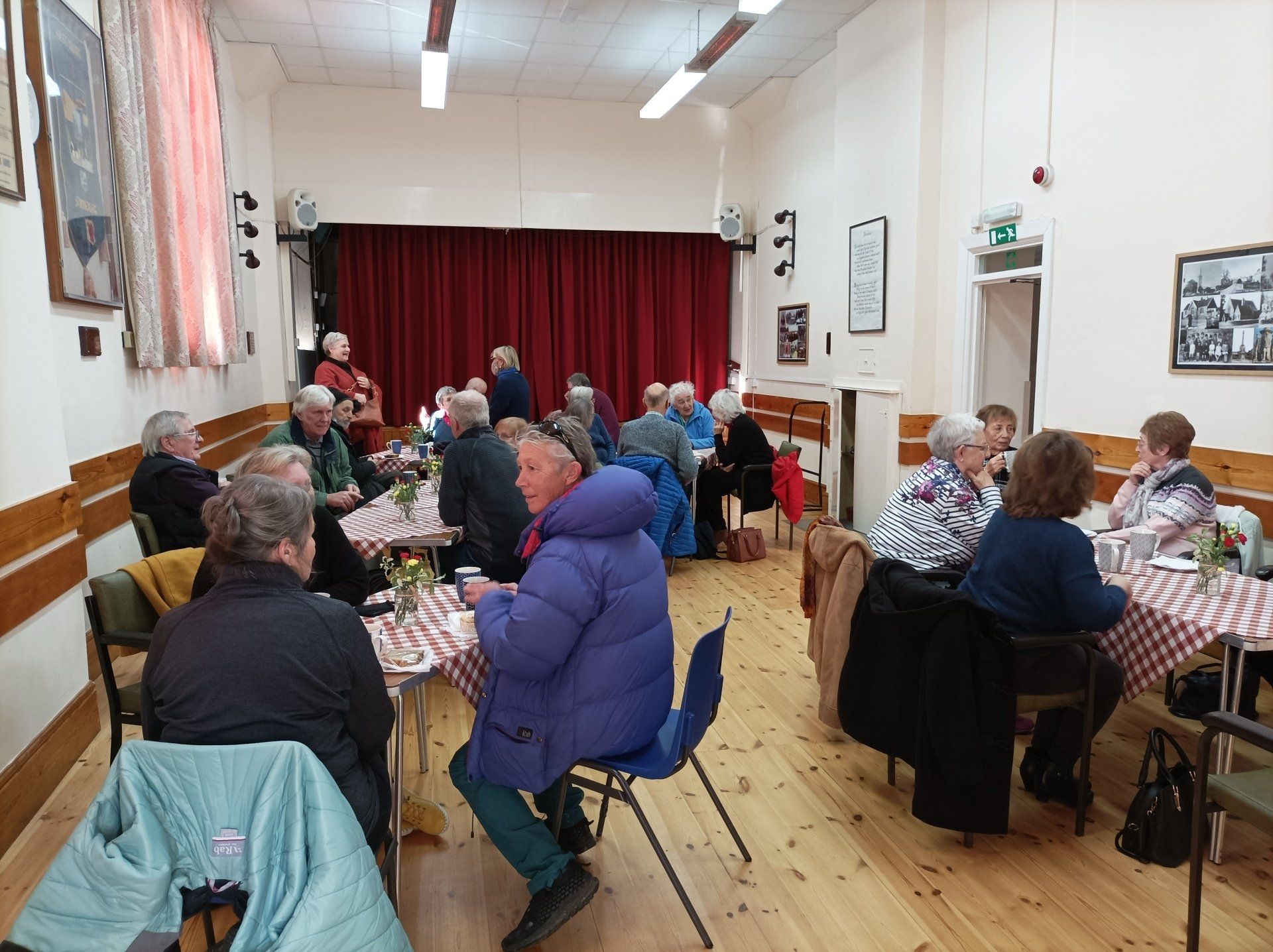 A group of people are sitting at tables in a room.