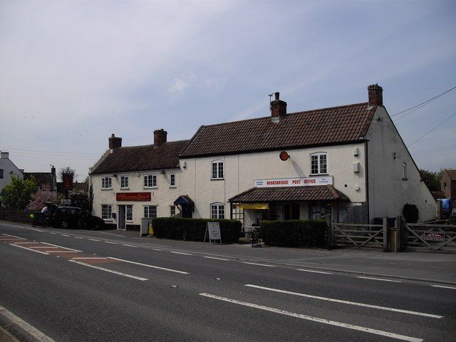A white building with a red sign that says ' a ' on it