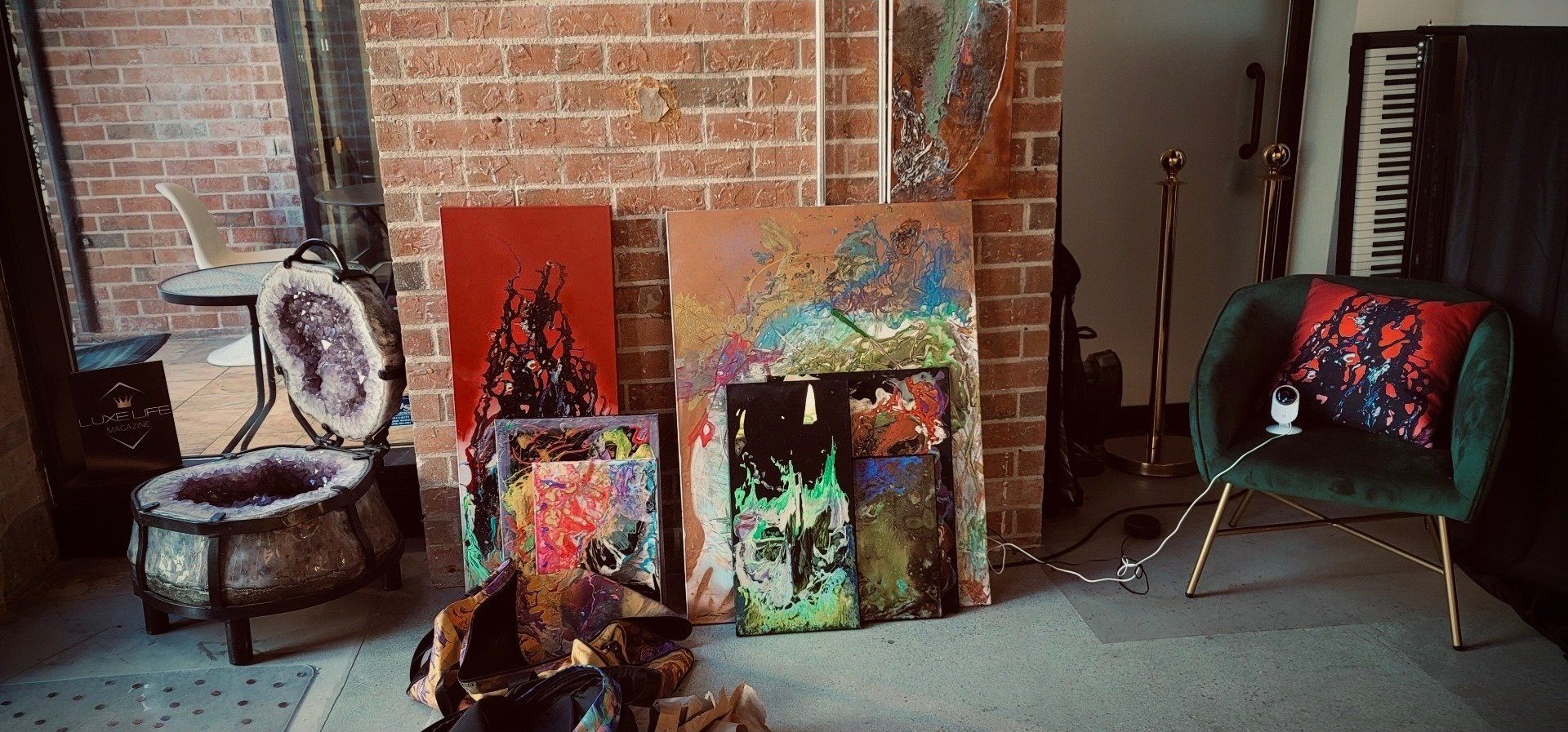 A living room with a fireplace and paintings on the wall.