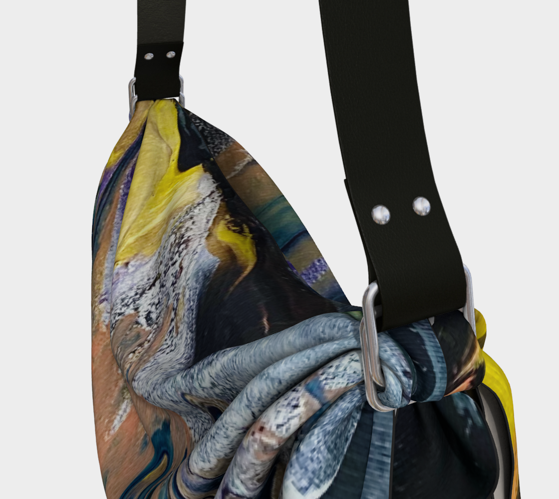 A purse with a black strap has a painting on it