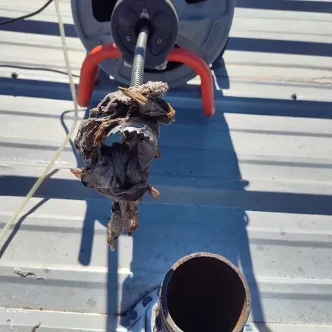 A close up of a pipe with a hose attached to it