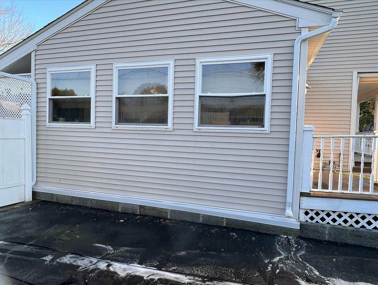 A house with a white fence and a lot of windows