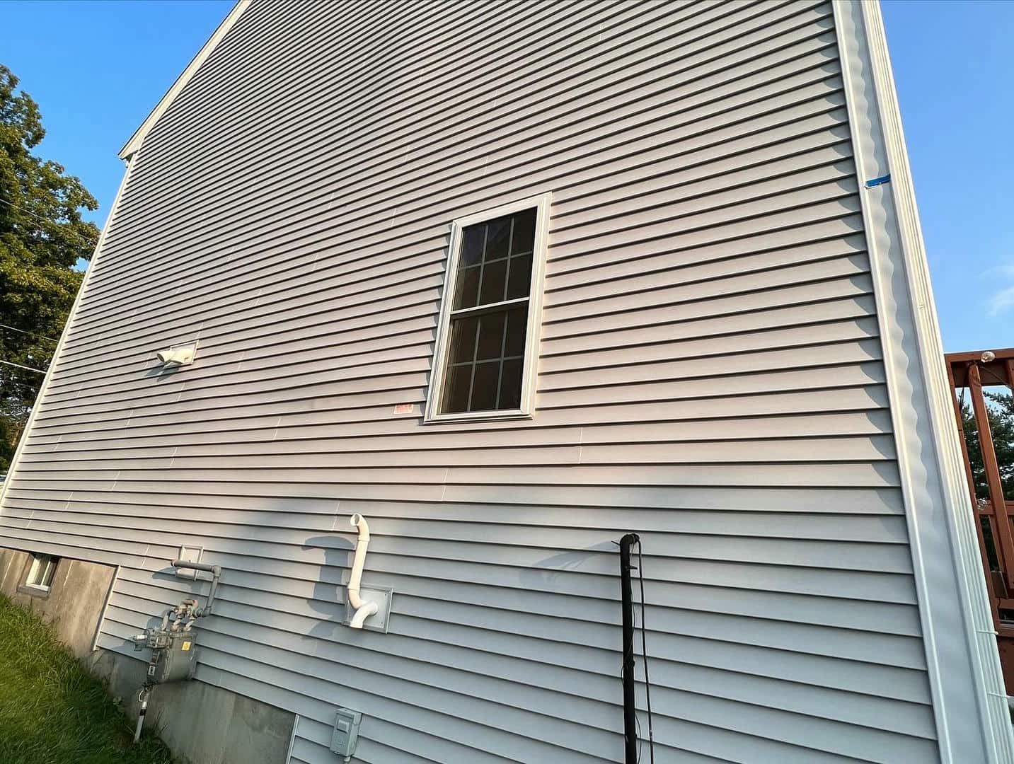 A white house with a window on the side of it.