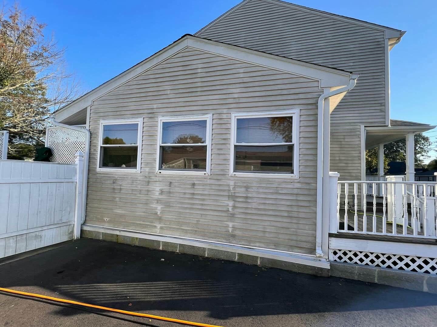 A house with a white fence and a lot of windows