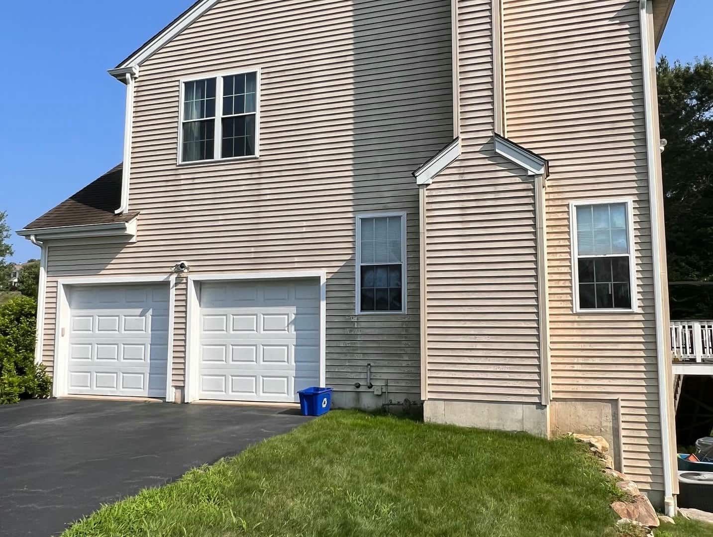 A large house with two garage doors and a driveway