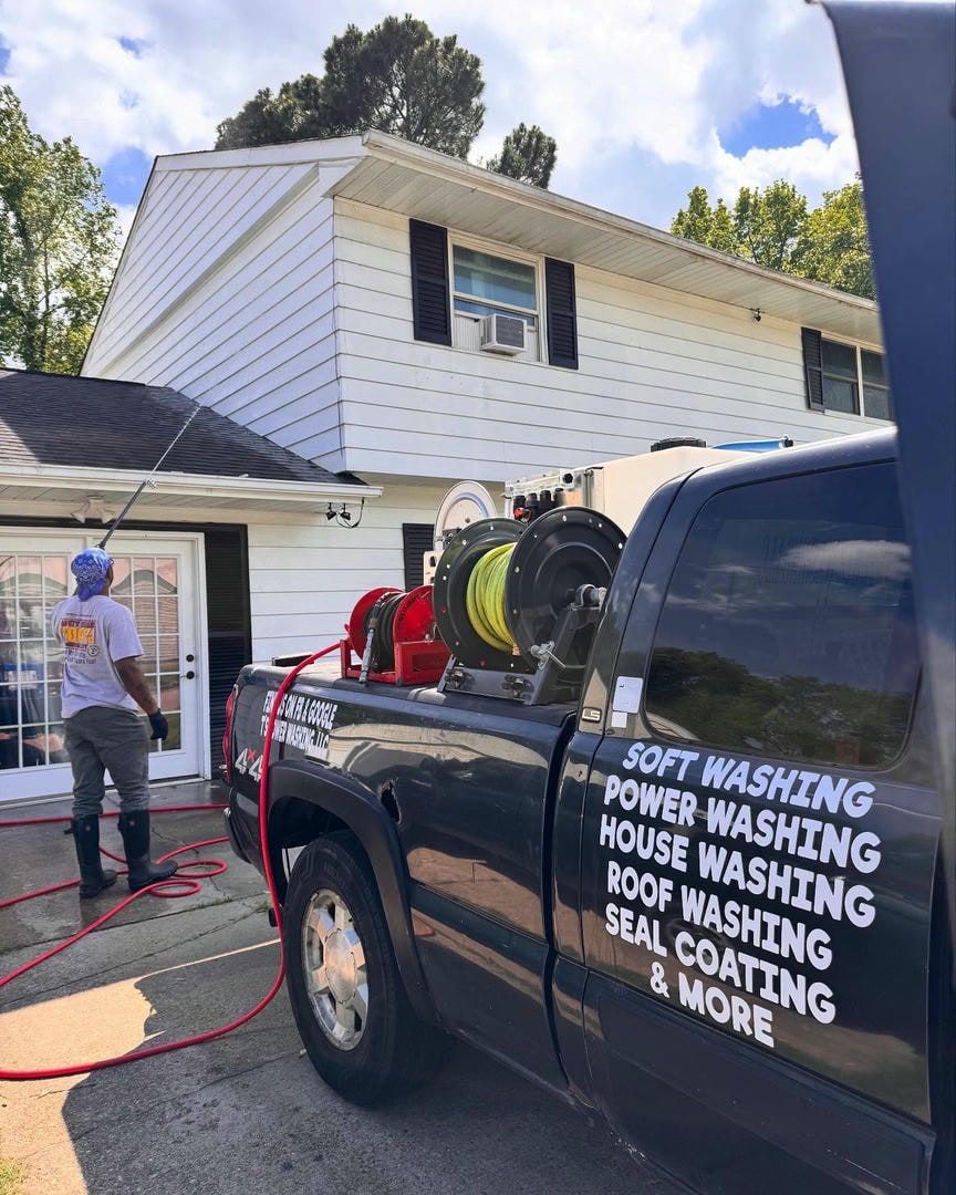 A truck that says soft washing power washing house washing roof washing seal coating and more
