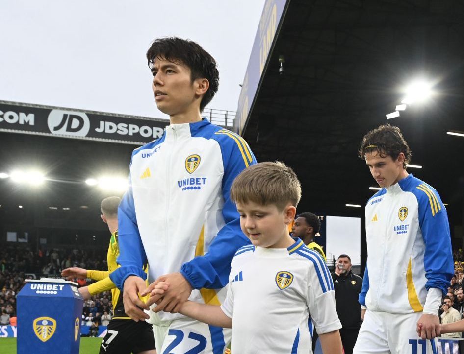 River Blackman walking out onto Elland Road with AO Tanaka