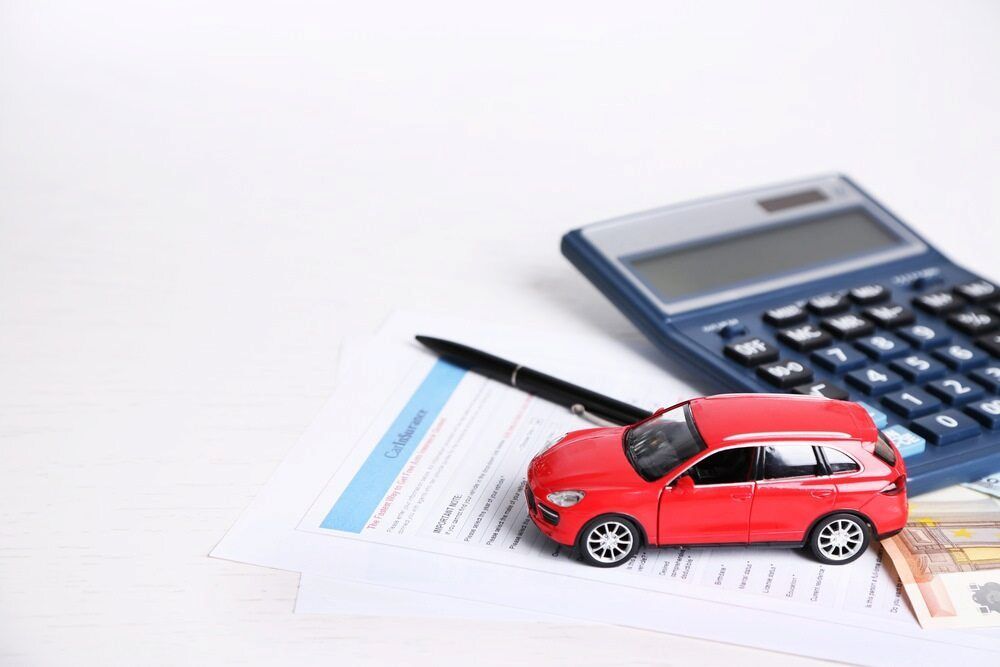 A Toy Car is Sitting on Top of a Piece of Paper Next to a Calculator and Pen — Seabreeze Auto Body in Coffs Harbour, NSW
