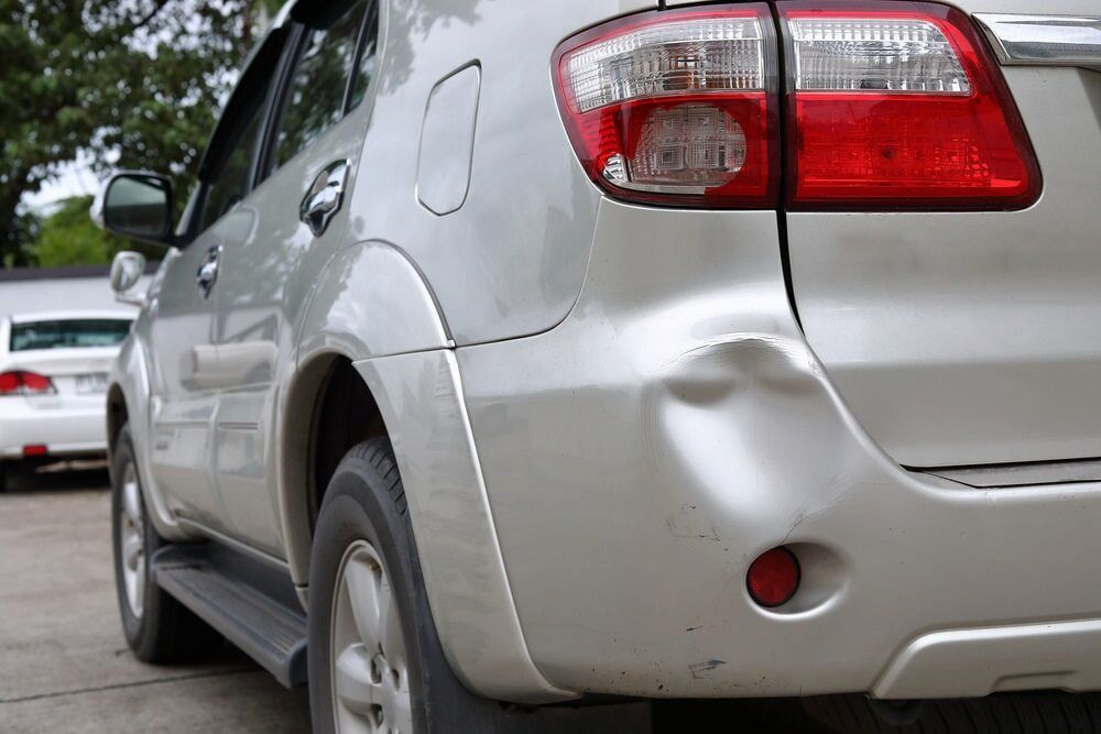 A Silver Car With a Damaged Bumper is Parked in a Parking Lot — Seabreeze Auto Body in Coffs Harbour, NSW