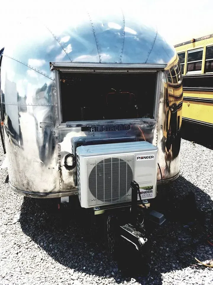 An airstream trailer with an air conditioner attached to it