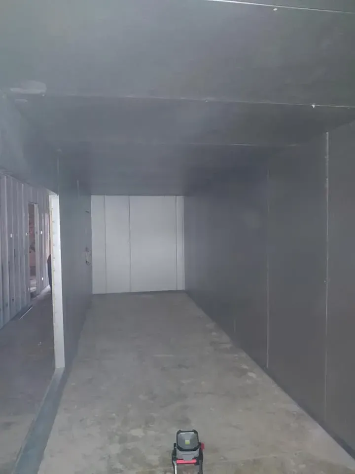 There is a vacuum cleaner in the middle of the room.