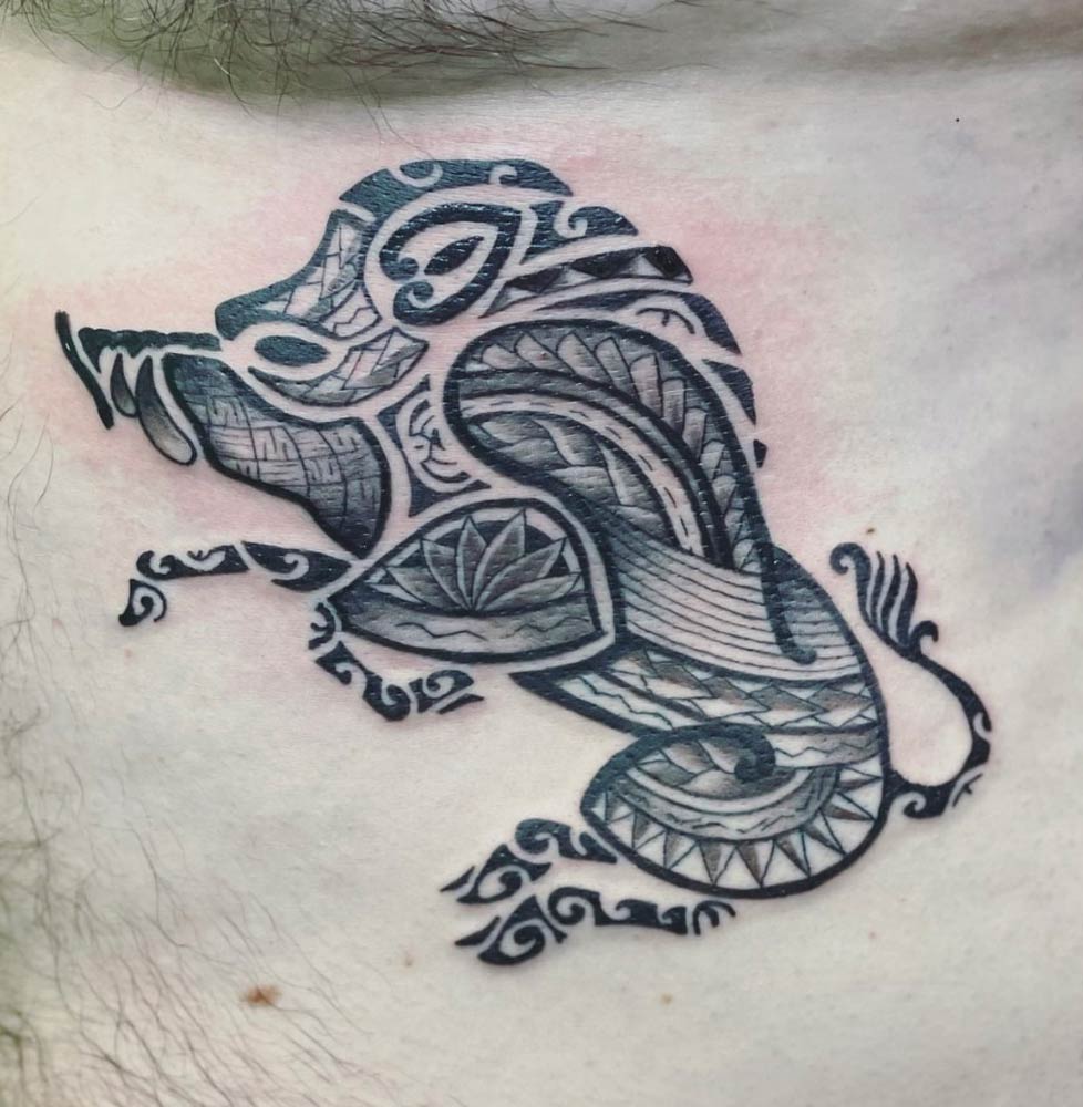 A black and white tattoo on a man 's chest