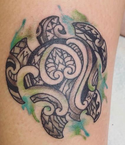 A tattoo of a sea turtle on a person 's leg
