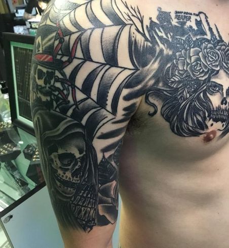 A man has a tattoo of a spider web on his shoulder