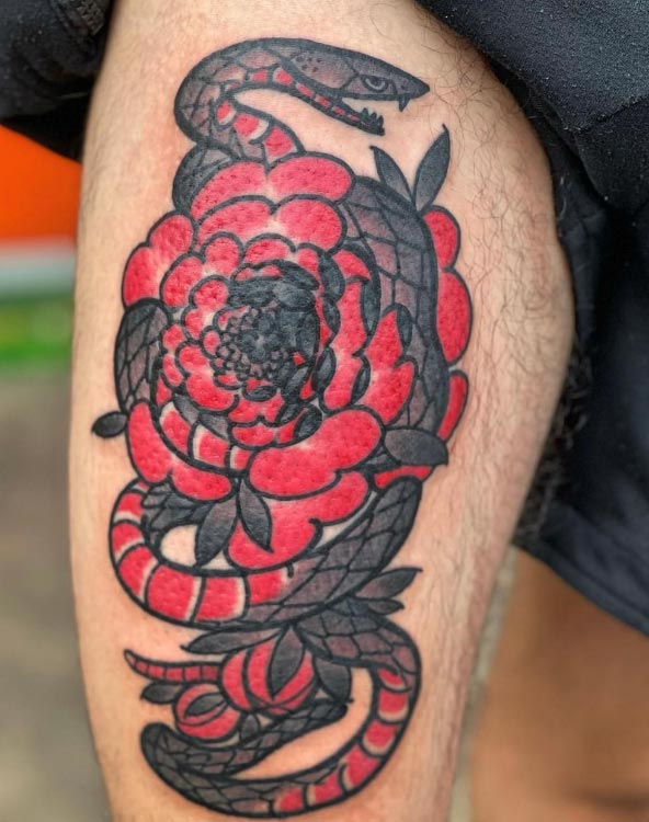 Tattoo of a snake coiled around a detailed flower, bold custom ink at Aloha Tattoo in Waikiki