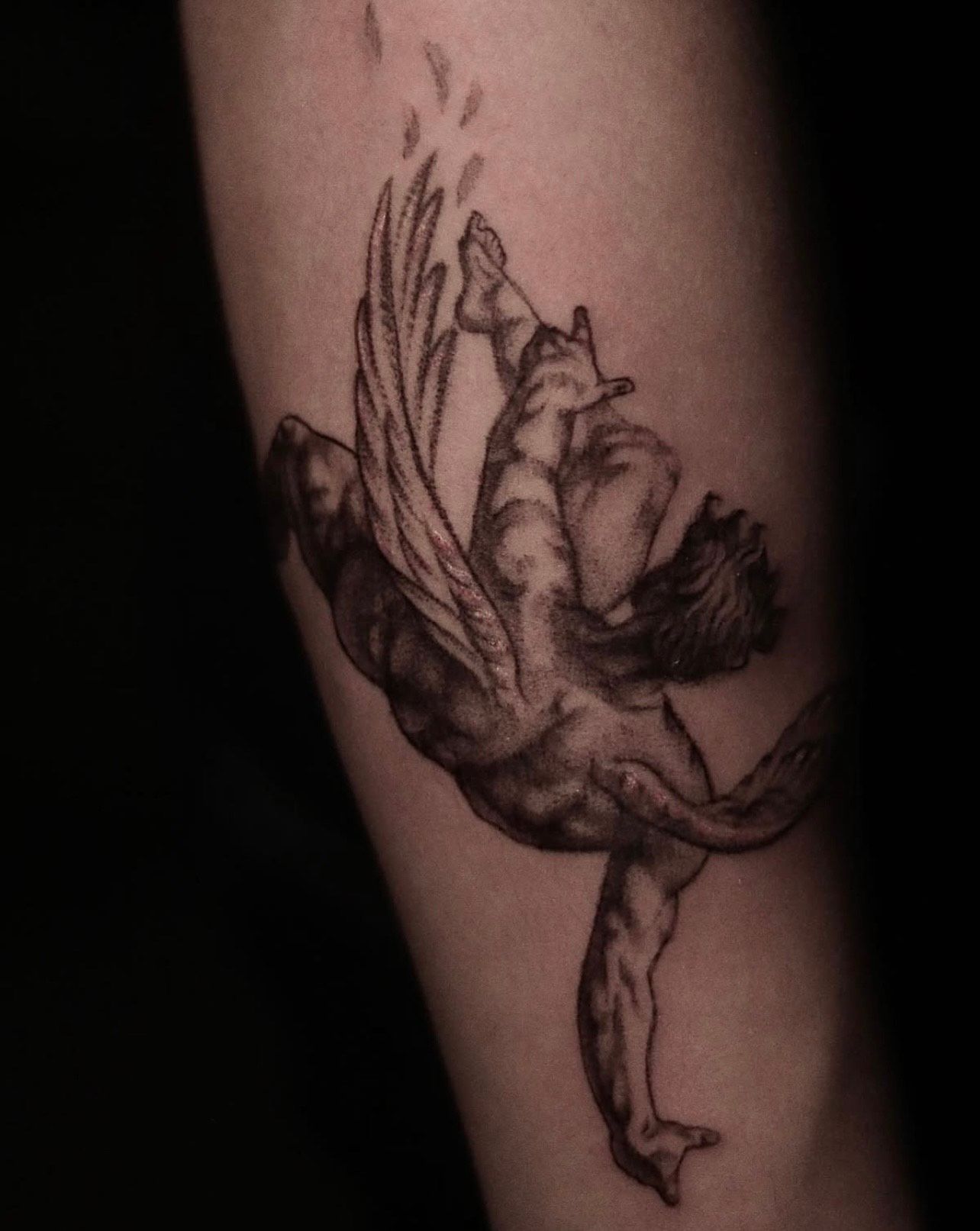 Realism tattoo of a winged mythological figure in motion—illustrative black and grey work by guest tattoo artist at Aloha Tattoo Waikiki near Hilton Hawaiian Village, Oahu