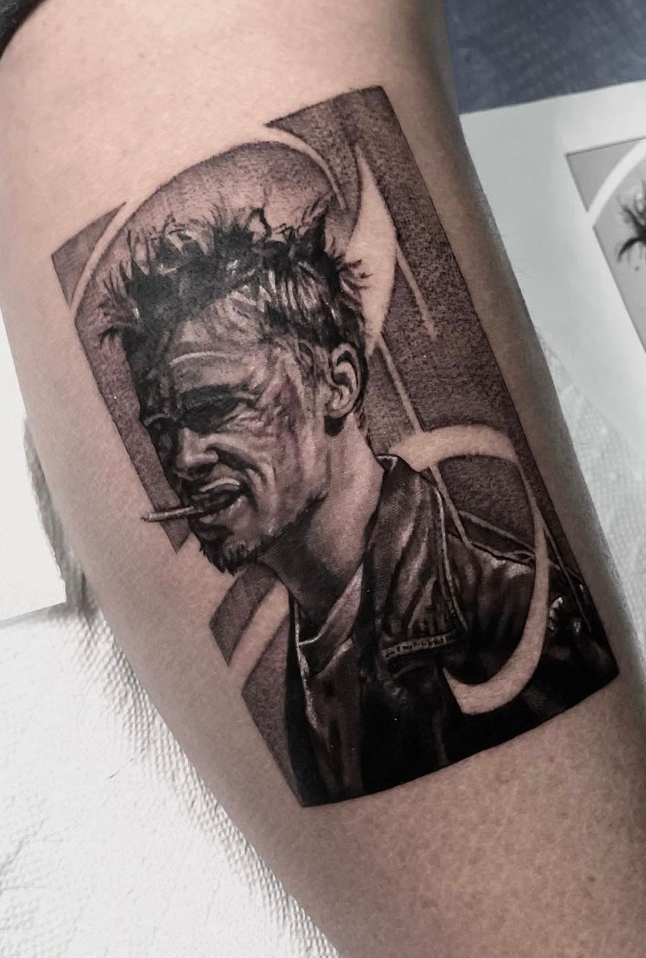 Realism tattoo of a leather-jacketed figure with detailed shading and abstract background—guest artist work at Aloha Tattoo Waikiki near Hilton Hawaiian Village, Honolulu