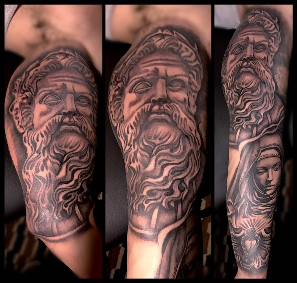 A black and white tattoo of a man with a beard and a woman.