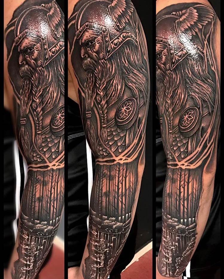 A black and brown tattoo of a viking on a man 's arm.
