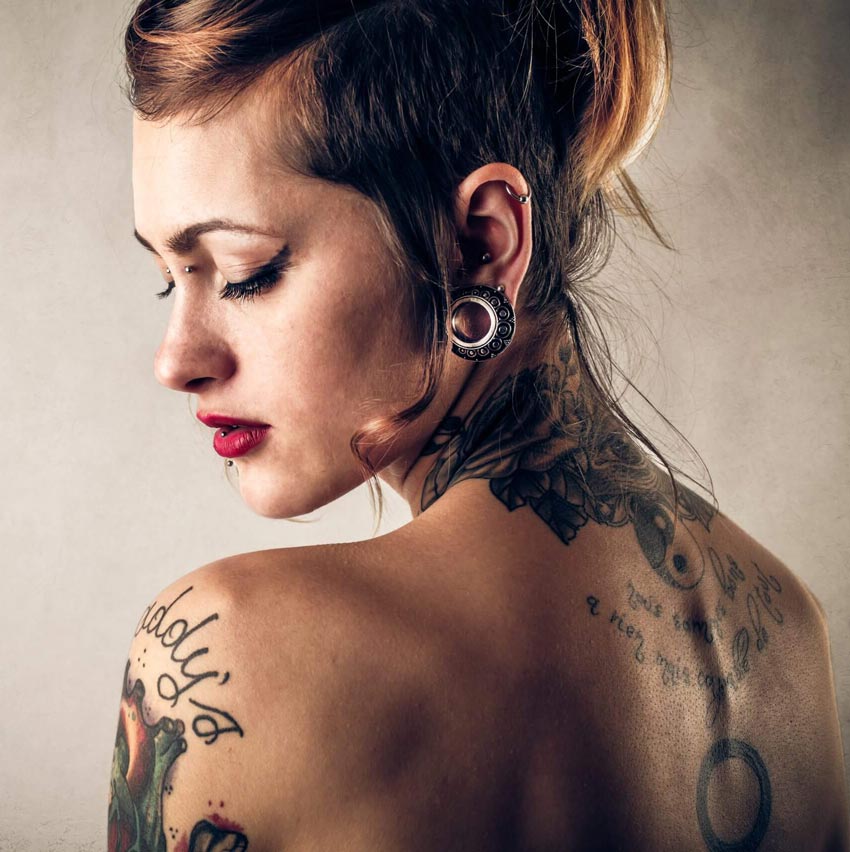 A woman with multiple piercings and tattoos at Aloha Tattoo in Honolulu, Waikiki, Hawaii
