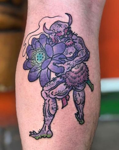 A tattoo of a monster holding a purple flower on a person 's leg.