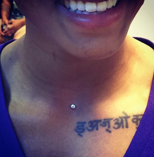 A woman has a tattoo on her chest that says ' i am a king '