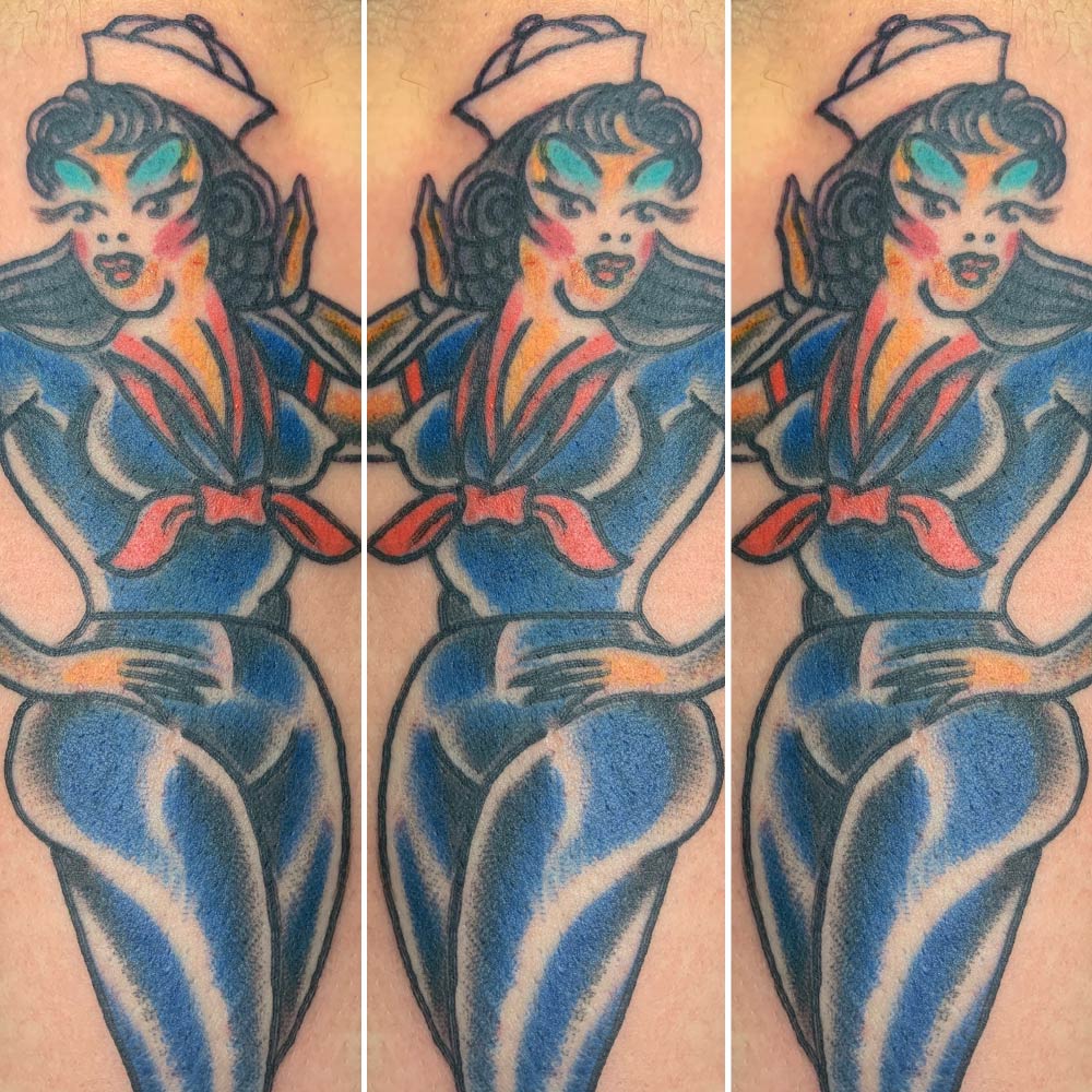 A tattoo of a woman in a sailor outfit